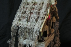 “The Sickness” side detail - 2014 - Mixed media, including menstrual blood and human hair, on a birdhouse with LED light and switch - 20 1/2” x 9” x 6” - Available - Message for details